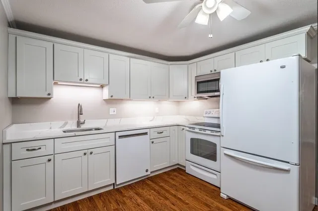 a kitchen with appliances cabinets and a sink