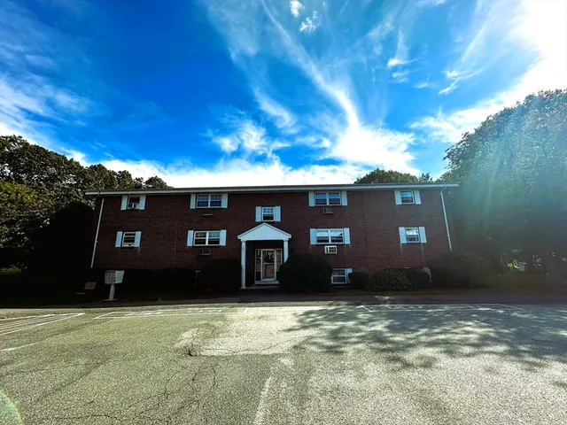 a view of a brick house with a large window