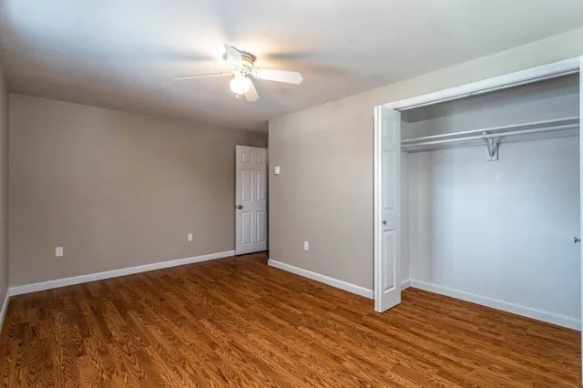 a view of an empty room with wooden floor