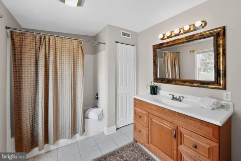 a bathroom with a sink vanity and a mirror