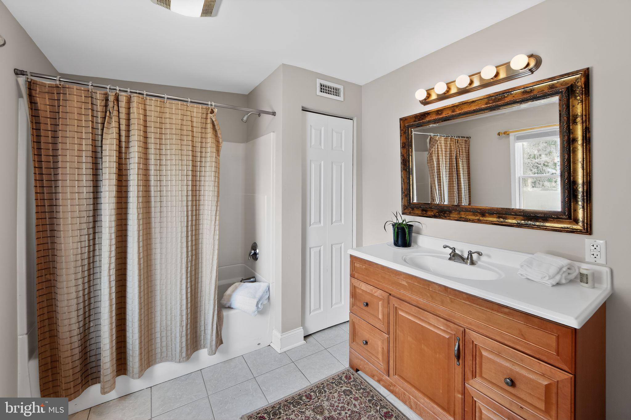 14 North Concord Road West Chester, PA 19380 - Photo 16 of 25 a bathroom with a sink vanity and a mirror