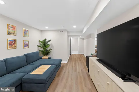 a living room with furniture and a potted plant