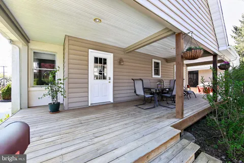 a view of a patio with table and chairs and wooden floor