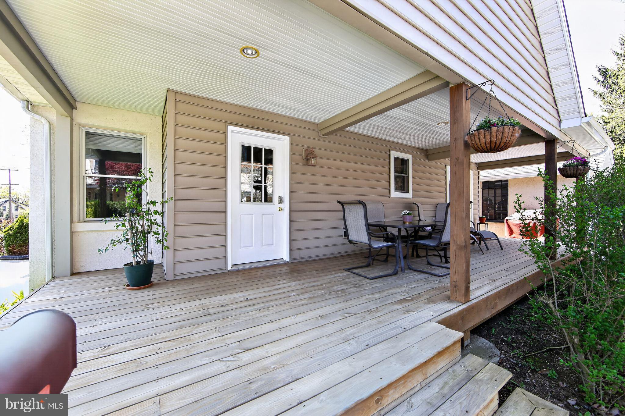 14 North Concord Road West Chester, PA 19380 - Photo 2 of 25 a view of a patio with table and chairs and wooden floor