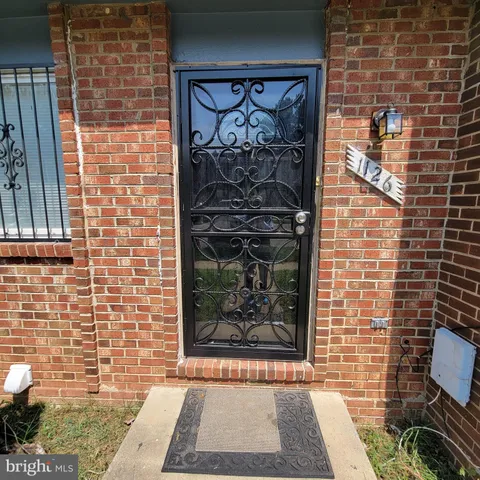 a view of a door with brick wall
