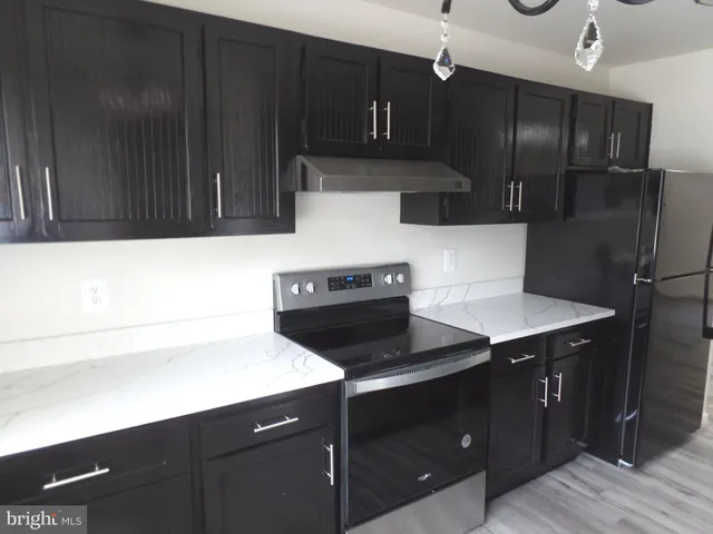 a kitchen with a sink stainless steel appliances and cabinets