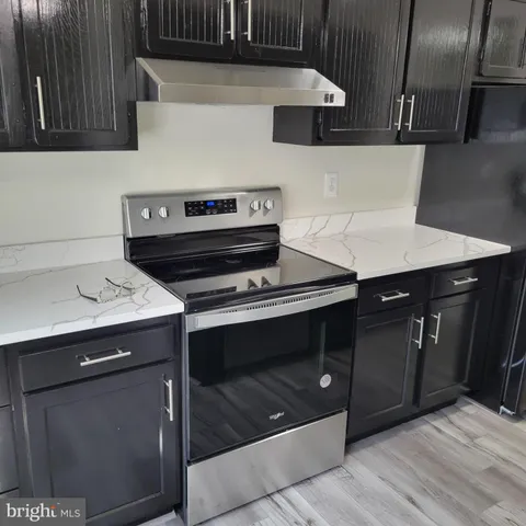 a stove top oven sitting inside of a kitchen