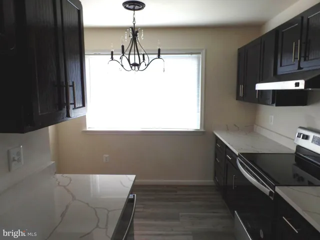 a kitchen with a sink and wooden floor