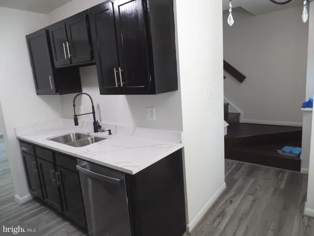 a kitchen with a sink and a mirror