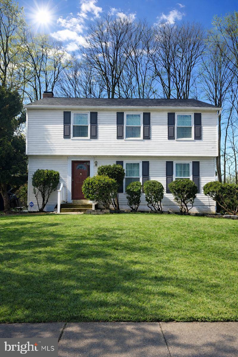 Charming home with lush green surroundings.