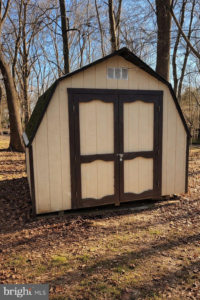 9839 Branchleigh Road Randallstown, MD 21133 - Photo 17 of 18 Garden shed nestled in nature.