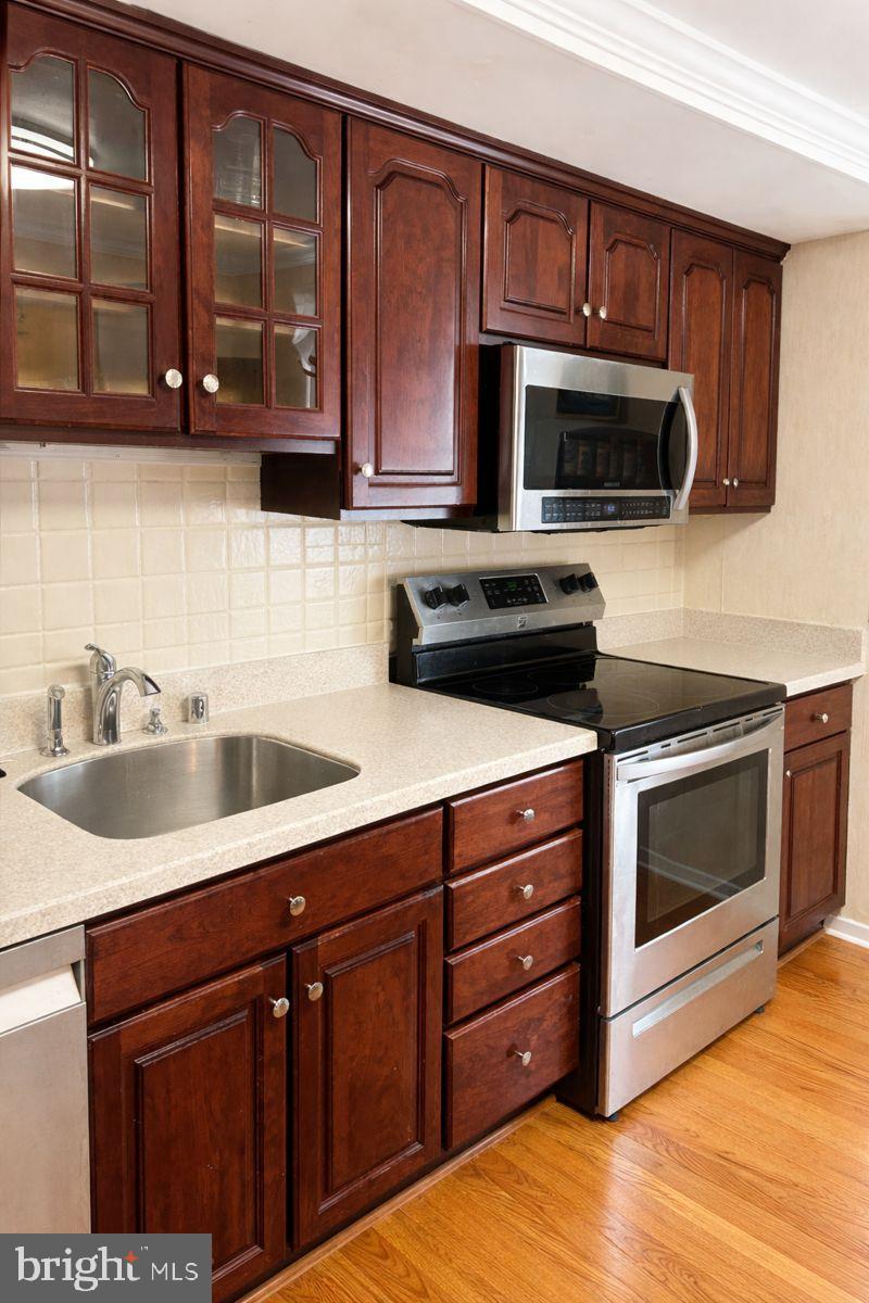 9839 Branchleigh Road Randallstown, MD 21133 - Photo 5 of 18 Modern kitchen with rich wood cabinetry.