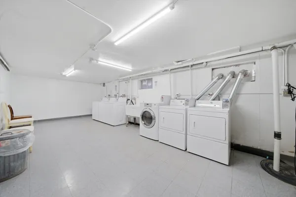 a view of a storage & utility room with two washing machine