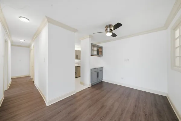 a view of a livingroom with wooden floor and a ceiling fan
