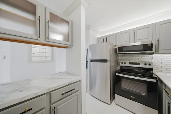 a kitchen with a refrigerator stove and microwave