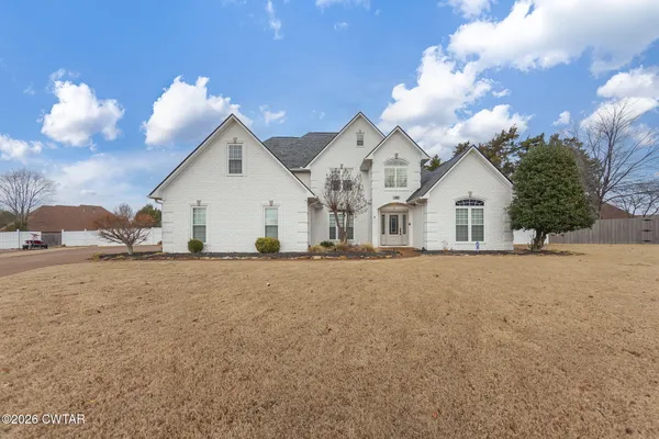 a view of empty room with wooden floor and fireplace