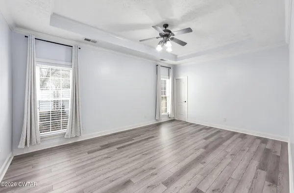 a view of a livingroom with wooden floor a fireplace and window