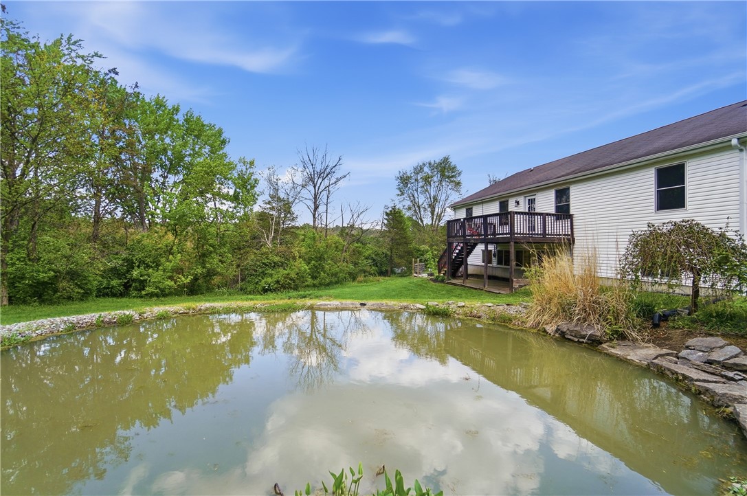 1208 Jarva Lane Springboro, OH 45066 - Photo 75 of 75 This serene setting features a tranquil pond with a spacious deck overlooking lush greenery.