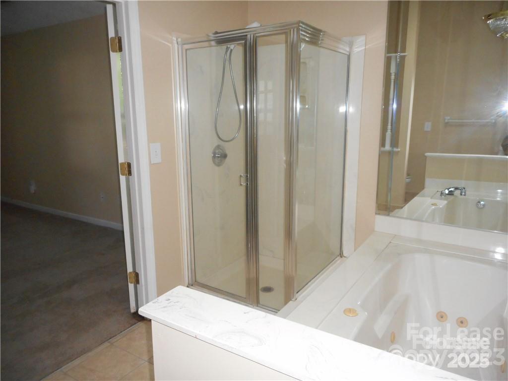 8319 Golf Ridge Drive Charlotte, NC 28277 - Photo 17 of 20 a bathroom with a bathtub and a shower
