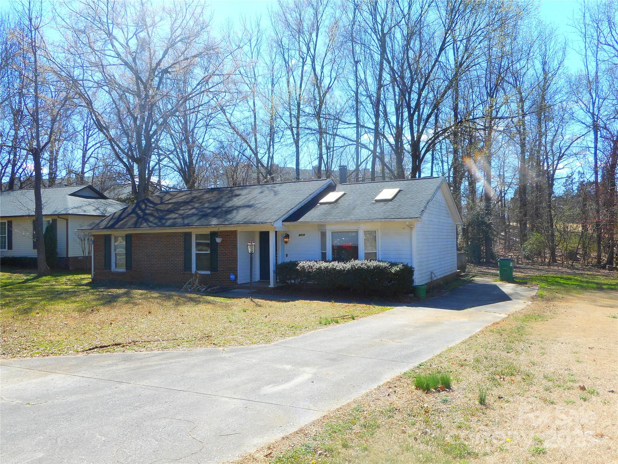 8319 Golf Ridge Drive Charlotte, NC 28277 - Photo 4 of 20 a front view of a house with a yard covered with snow and trees