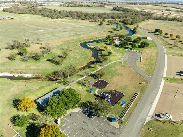a swimming pool with plants and large trees