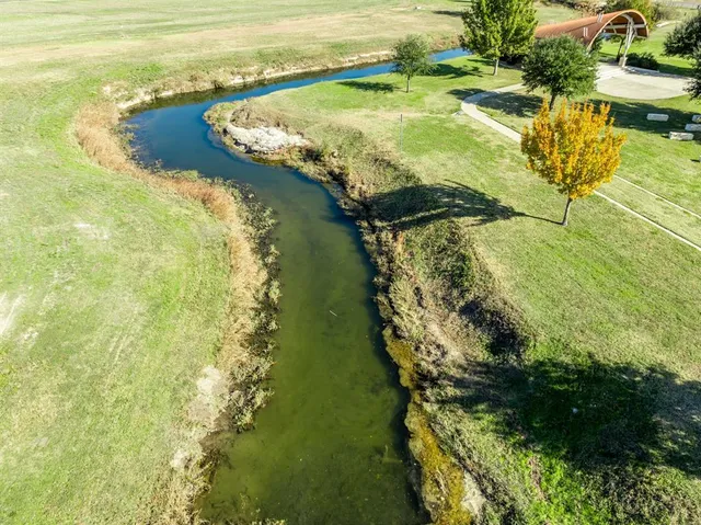 a view of a hallway with wooden floor and stairs
