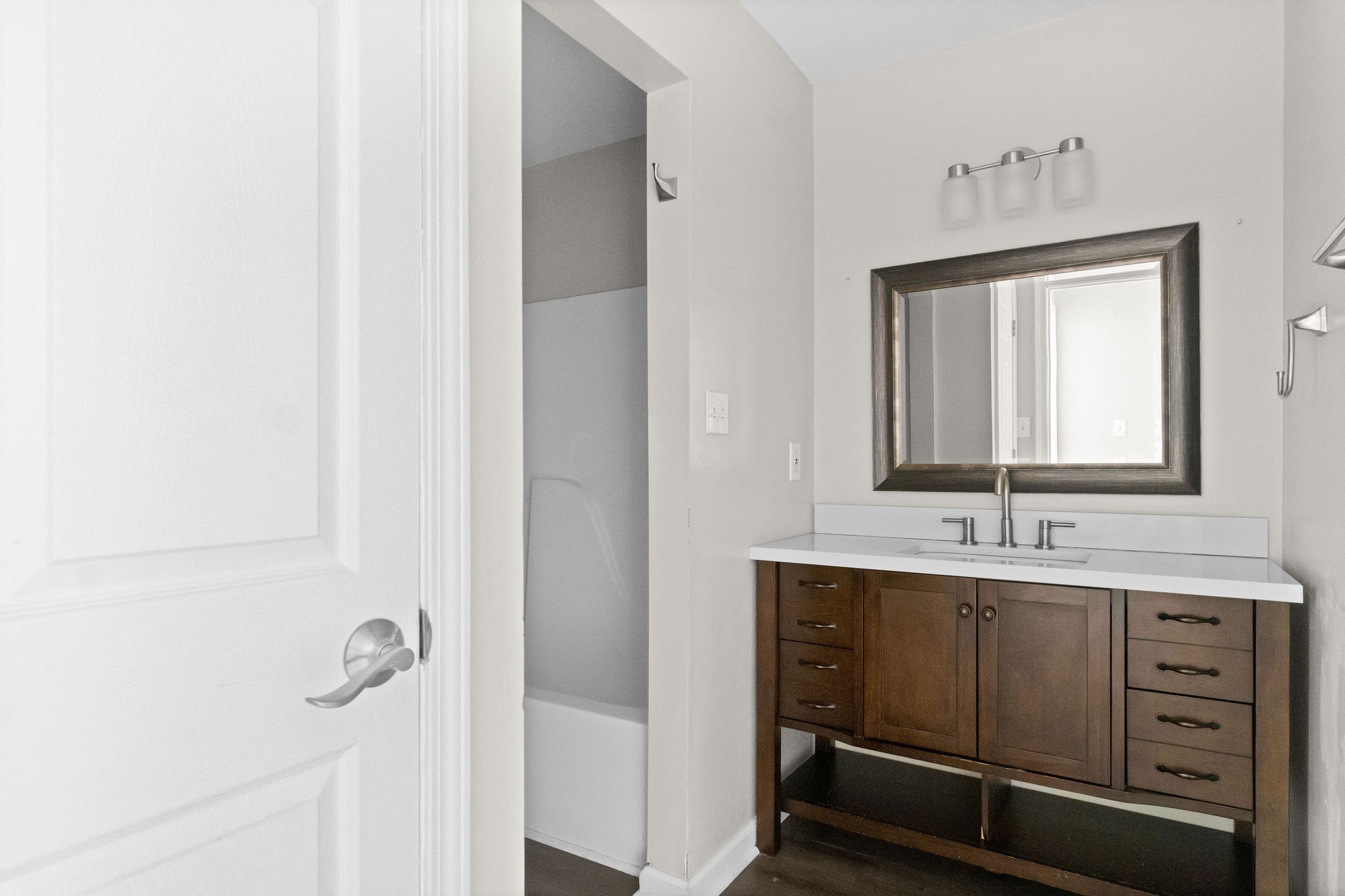 3855 Northeast Drive, Unit H Clarksville, TN 37040 - Photo 17 of 23 a bathroom with a sink a mirror and shower