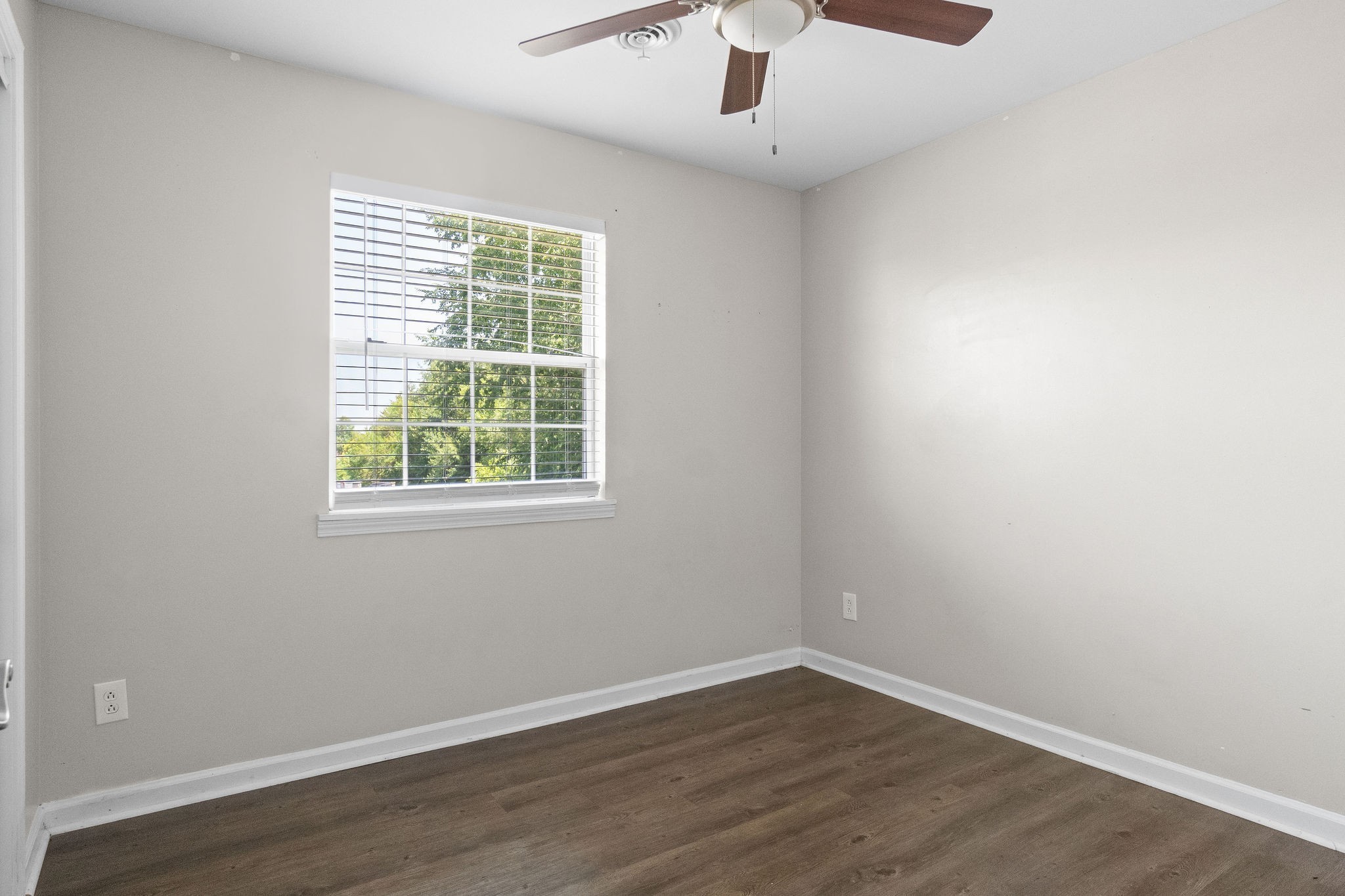 3855 Northeast Drive, Unit H Clarksville, TN 37040 - Photo 22 of 23 an empty room with a window and wooden floor