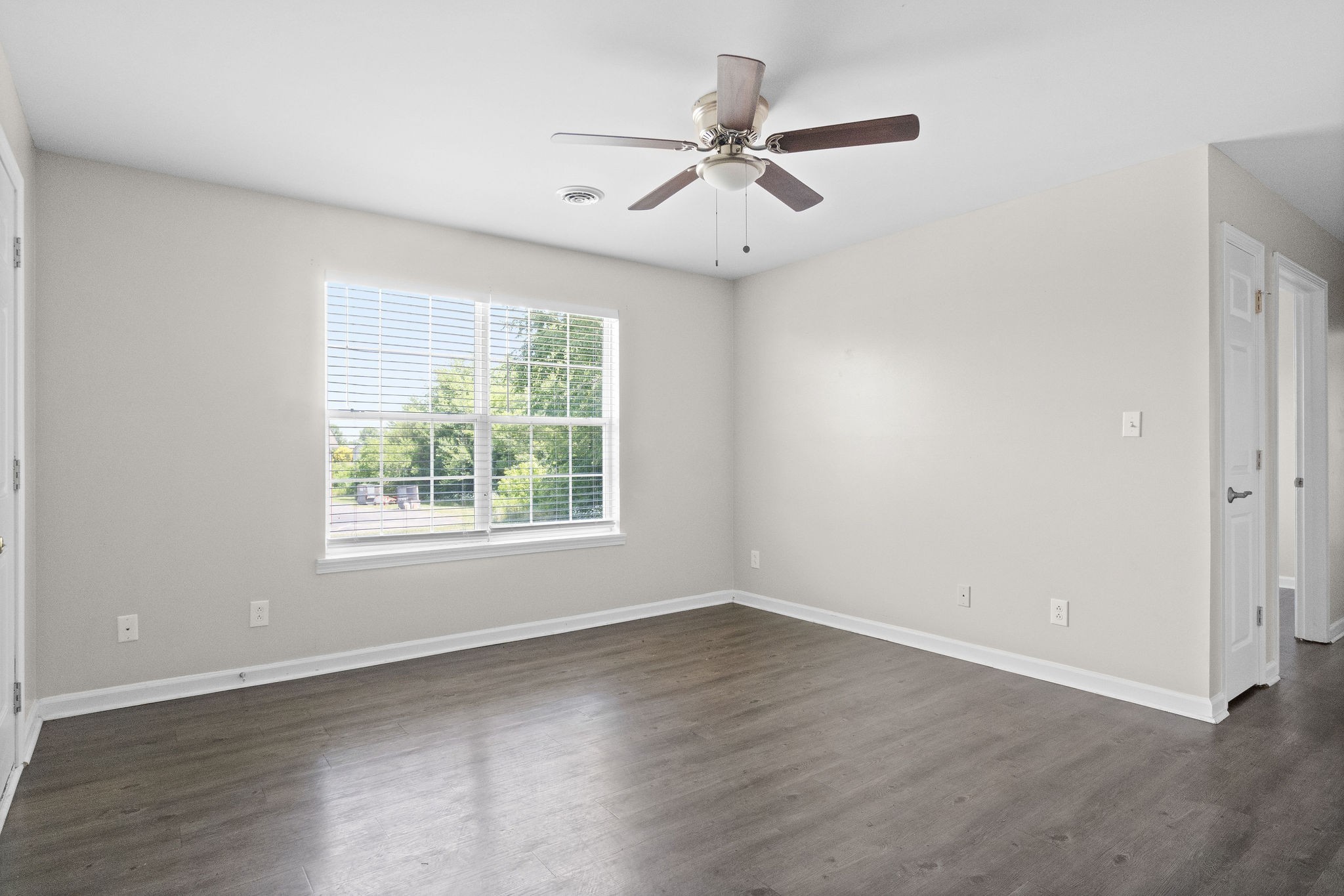 3855 Northeast Drive, Unit H Clarksville, TN 37040 - Photo 3 of 23 an empty room with wooden floor fan and windows