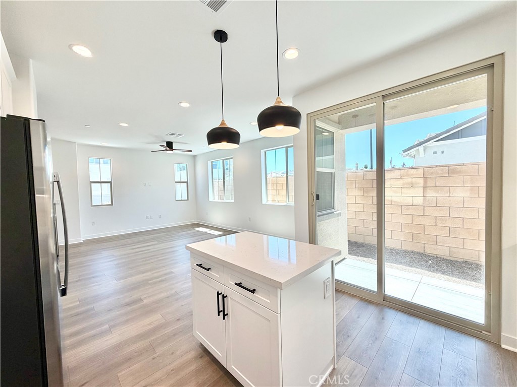 29561 Monarch Road Menifee, CA 92586 - Photo 12 of 35 a open kitchen with stainless steel appliances granite countertop a refrigerator a sink and a stove