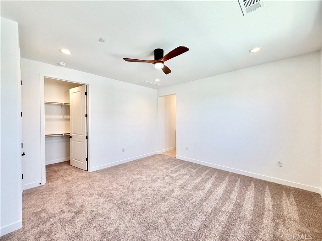 29561 Monarch Road Menifee, CA 92586 - Photo 17 of 35 an empty room with closet and windows