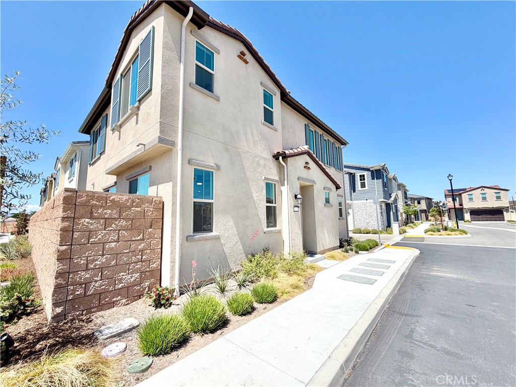 29561 Monarch Road Menifee, CA 92586 - Photo 2 of 35 a front view of a house with a yard