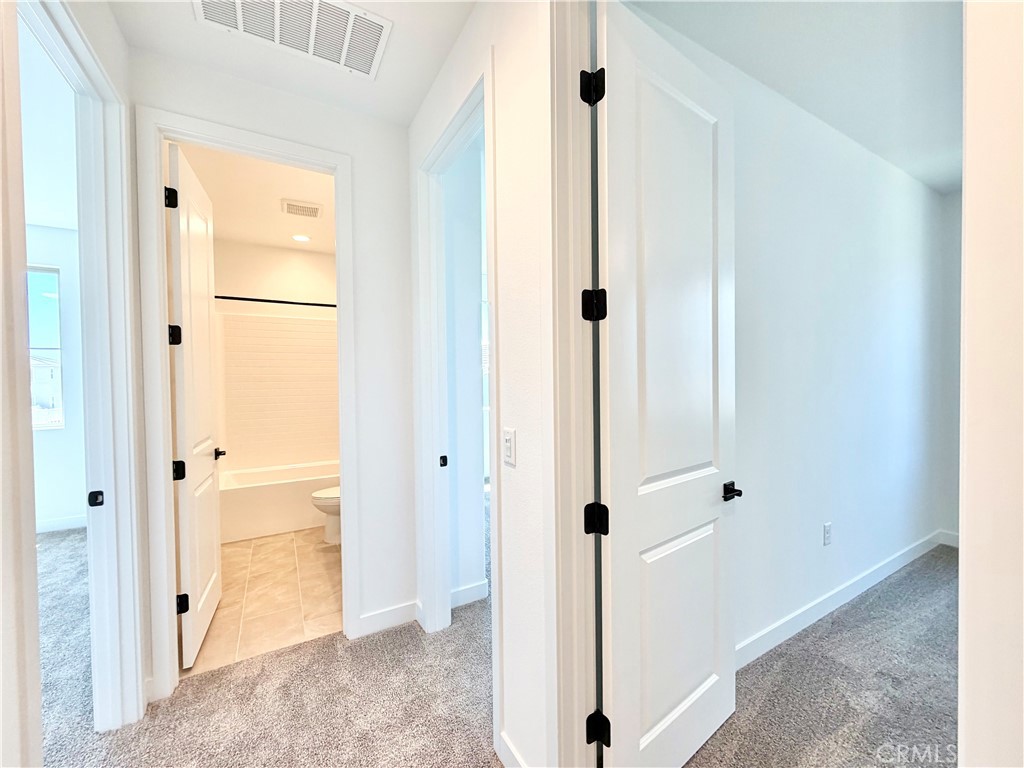 29561 Monarch Road Menifee, CA 92586 - Photo 23 of 35 a view of a bathroom with a glass door