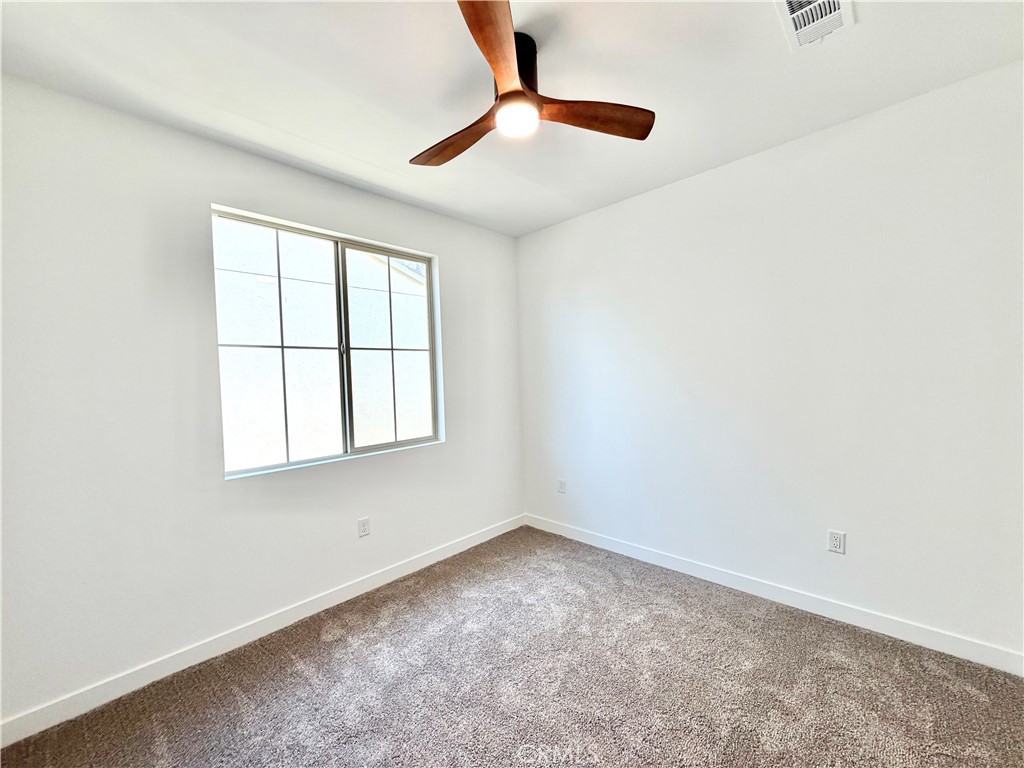29561 Monarch Road Menifee, CA 92586 - Photo 24 of 35 an empty room with windows