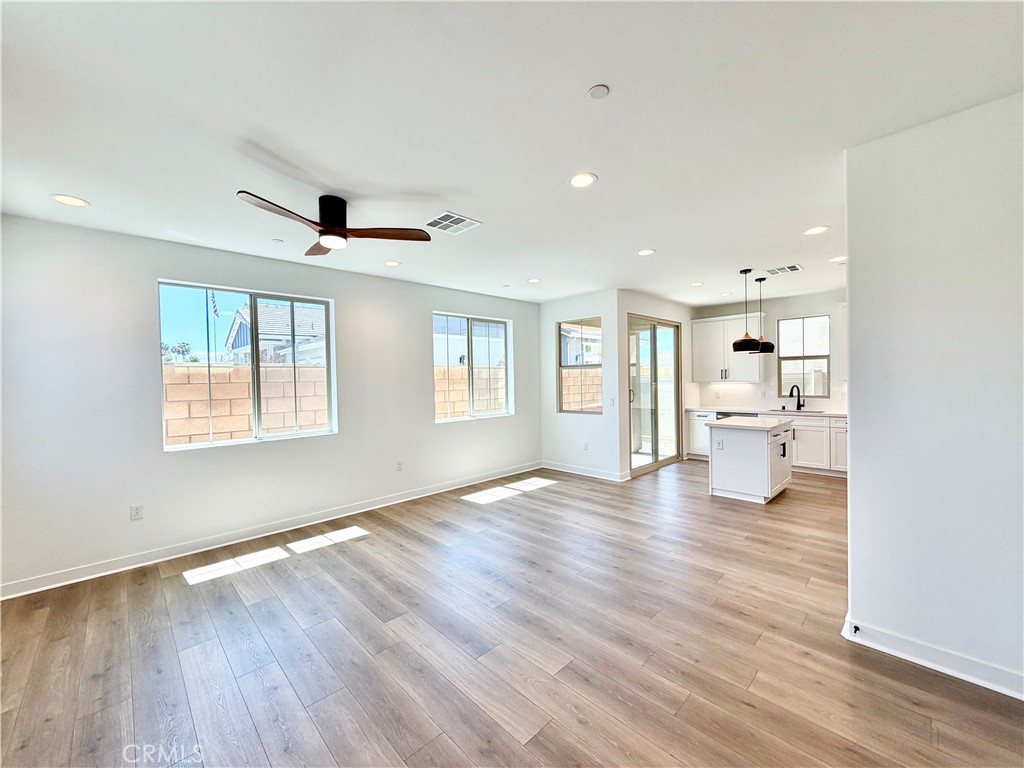 29561 Monarch Road Menifee, CA 92586 - Photo 8 of 35 a view of empty room with wooden floor and windows
