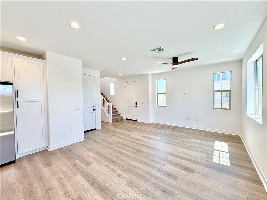 29561 Monarch Road Menifee, CA 92586 - Photo 10 of 35 a view of an empty room with wooden floor and a window