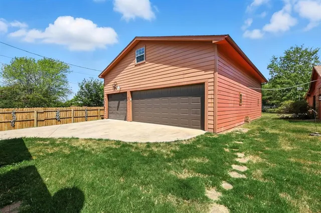 a view of backyard of house with green space