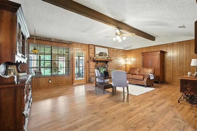 a living room filled furniture and a wooden floor
