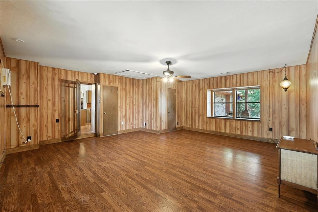 905 Clearview Drive Krum, TX 76249 - Photo 19 of 38 an empty room with wooden floor and windows