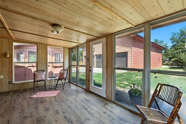 a room with wooden floors stairs and furniture
