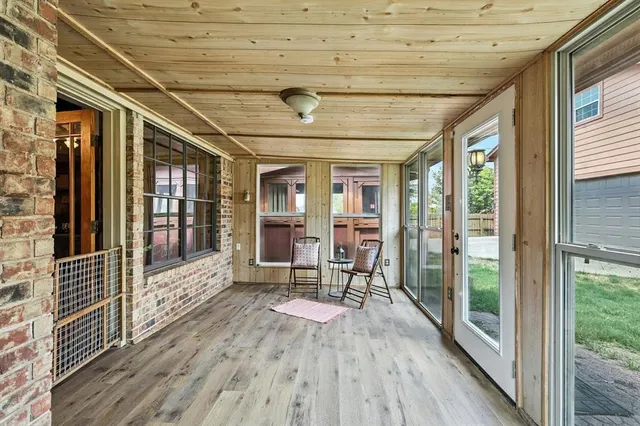 a view of a porch with wooden floor and iron stairs
