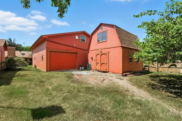 a backyard of a house with plants and entertaining space