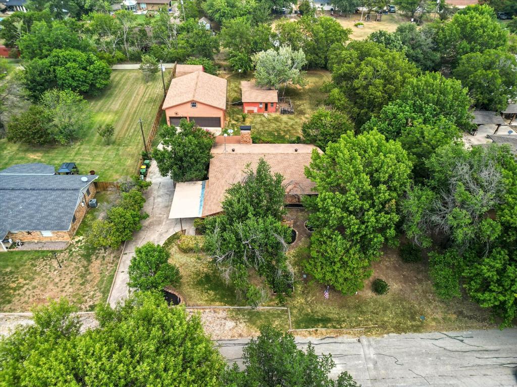 905 Clearview Drive Krum, TX 76249 - Photo 36 of 38 an aerial view of a house with a yard and greenery