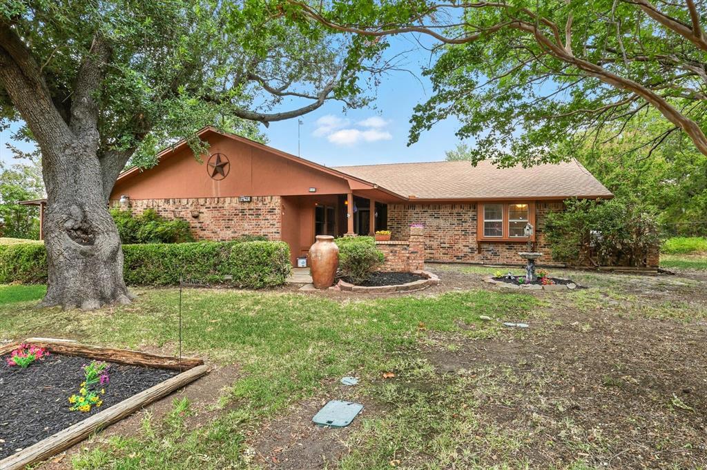 905 Clearview Drive Krum, TX 76249 - Photo 5 of 38 a front view of a house with garden