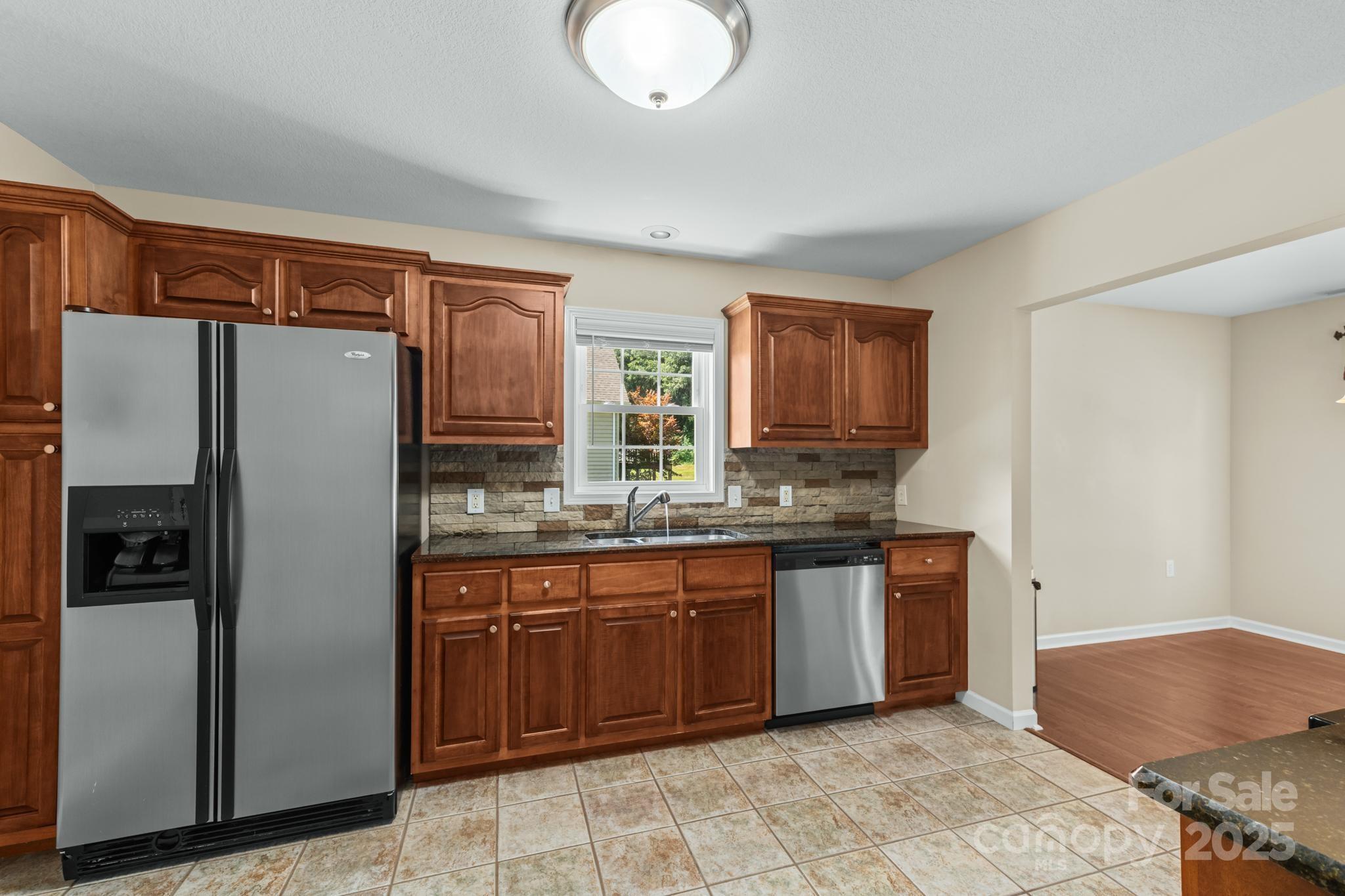 2133 Olde Farm Road Southeast Hudson, NC 28638 - Photo 12 of 42 a kitchen with stainless steel appliances granite countertop a refrigerator and a stove top oven