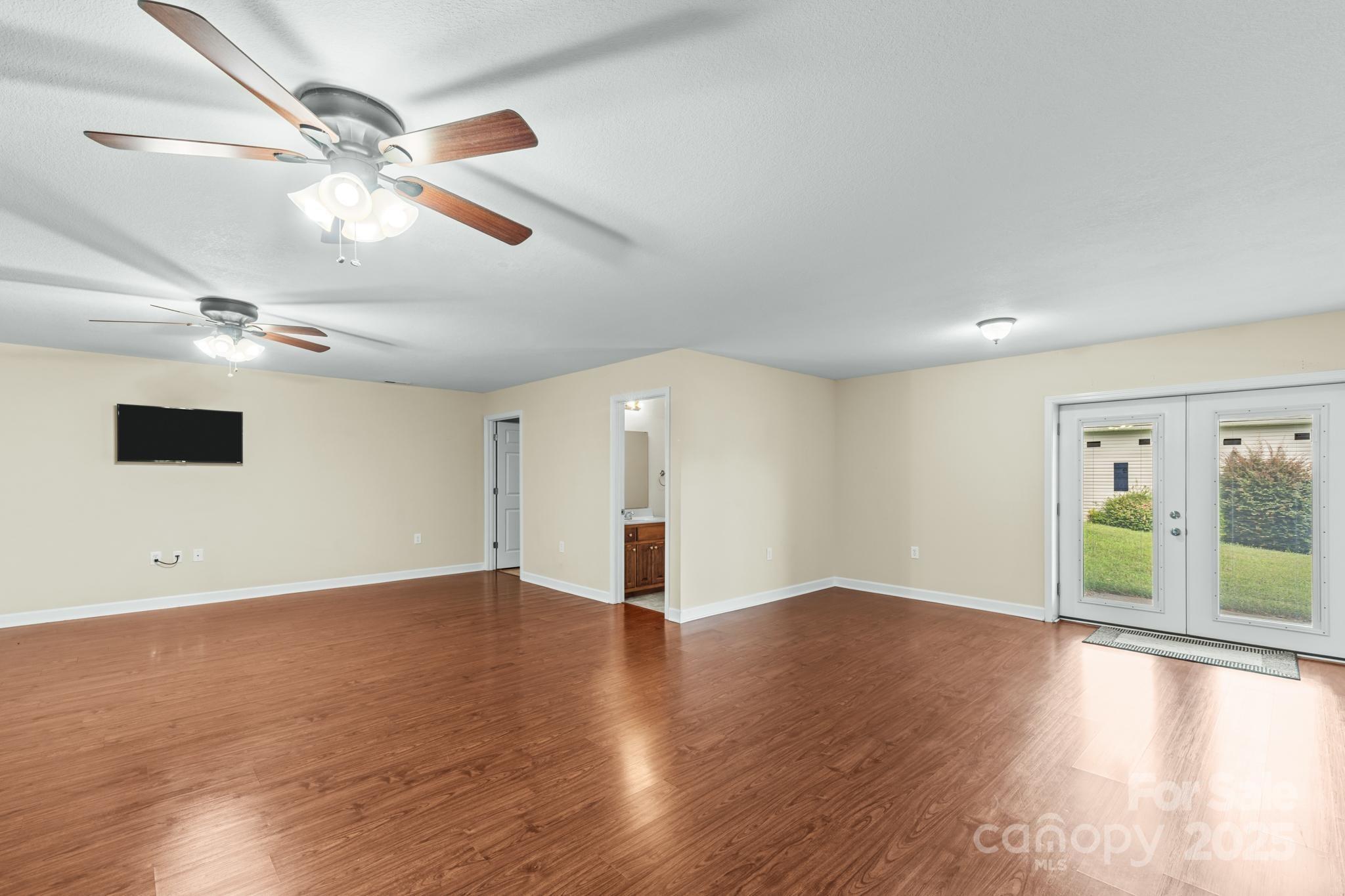 2133 Olde Farm Road Southeast Hudson, NC 28638 - Photo 14 of 42 a view of an empty room with wooden floor and a window