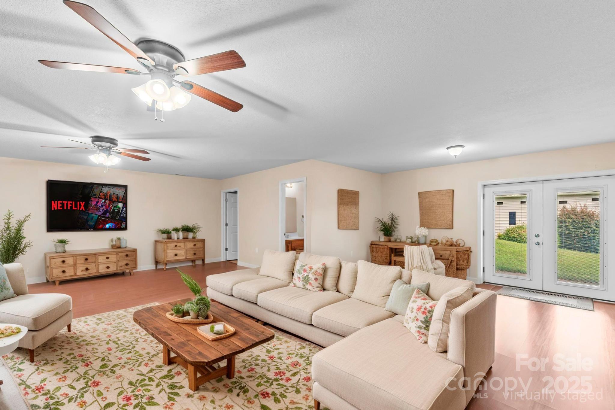 2133 Olde Farm Road Southeast Hudson, NC 28638 - Photo 16 of 42 a living room with furniture a flat screen tv and a large window
