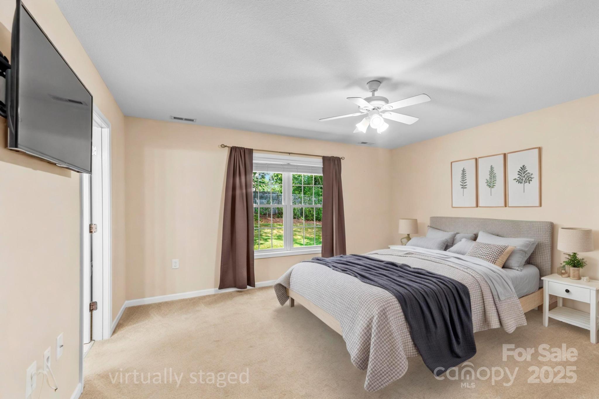 2133 Olde Farm Road Southeast Hudson, NC 28638 - Photo 23 of 42 a bedroom with a large bed and a chandelier