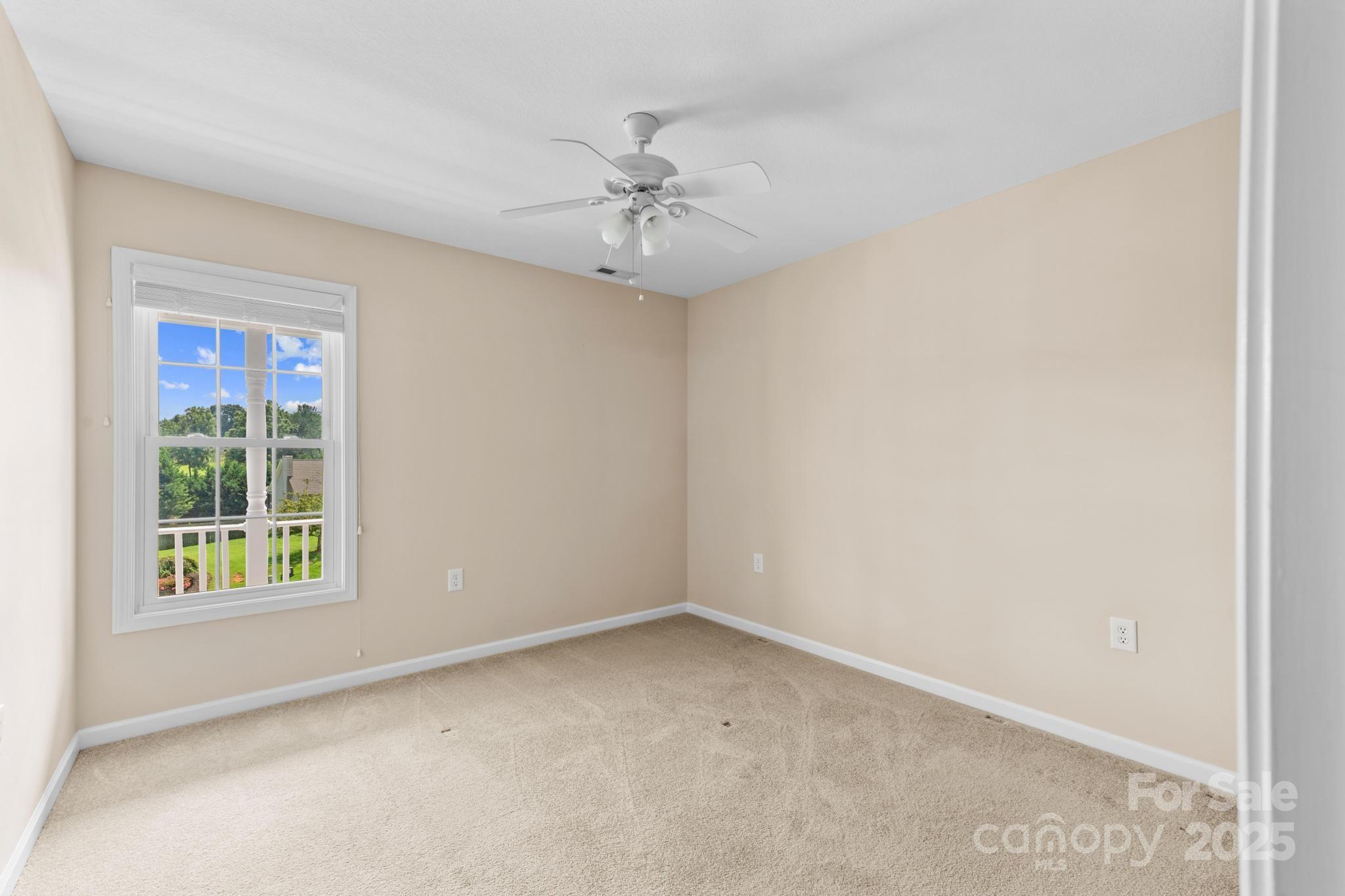 2133 Olde Farm Road Southeast Hudson, NC 28638 - Photo 24 of 42 an empty room with a window and a fan