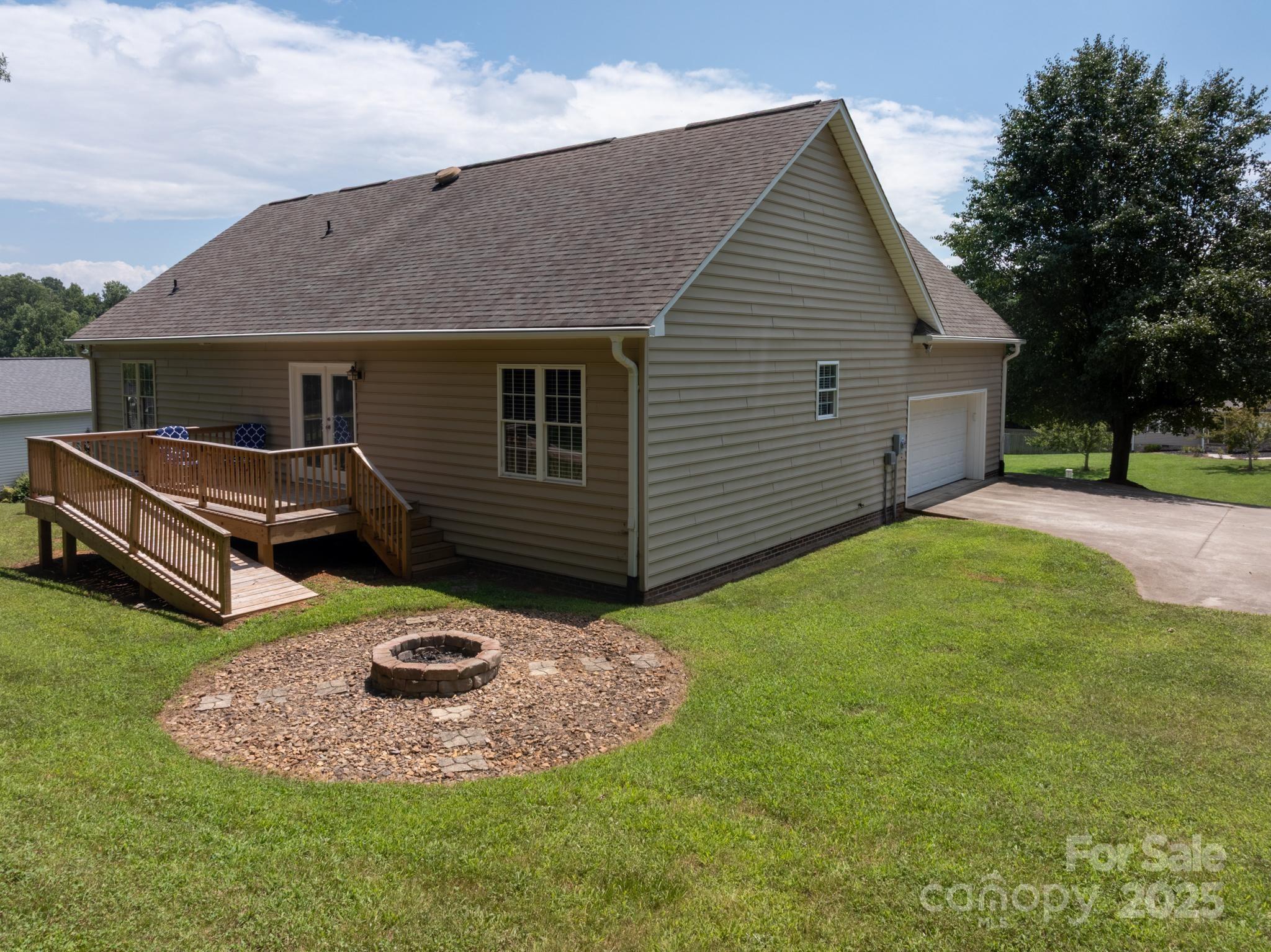 2133 Olde Farm Road Southeast Hudson, NC 28638 - Photo 37 of 42 a backyard of a house with yard and trampoline